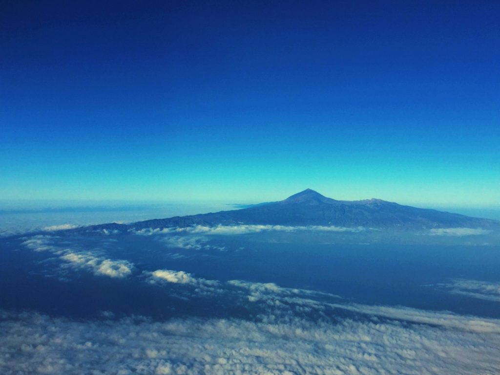 mountain with clouds under blue sky