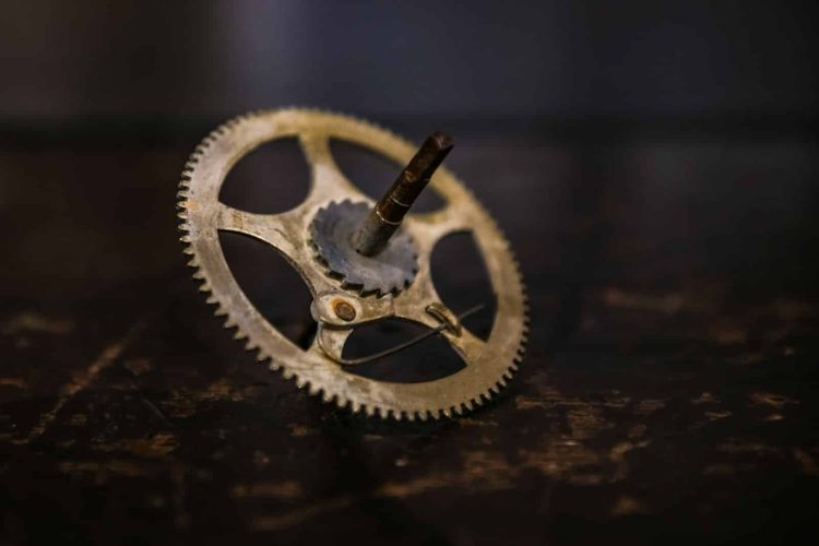 brown sprocket with bearing and metal rod