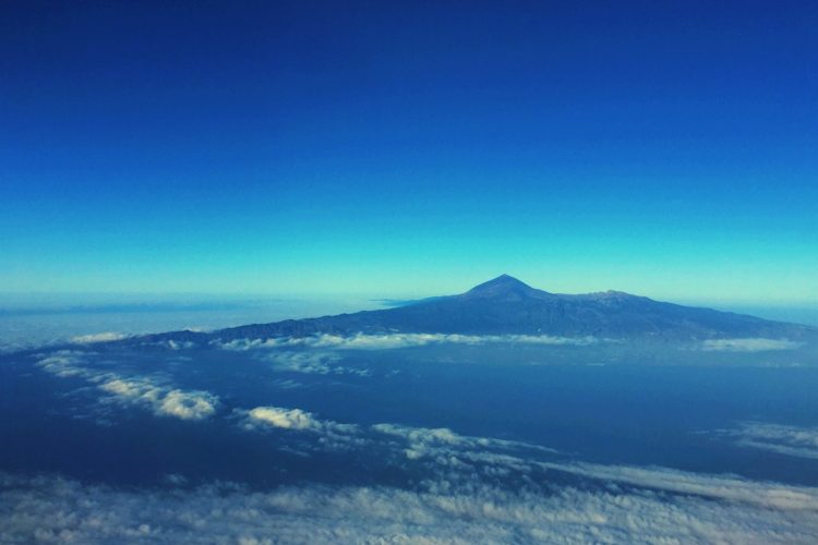 mountain with clouds under blue sky