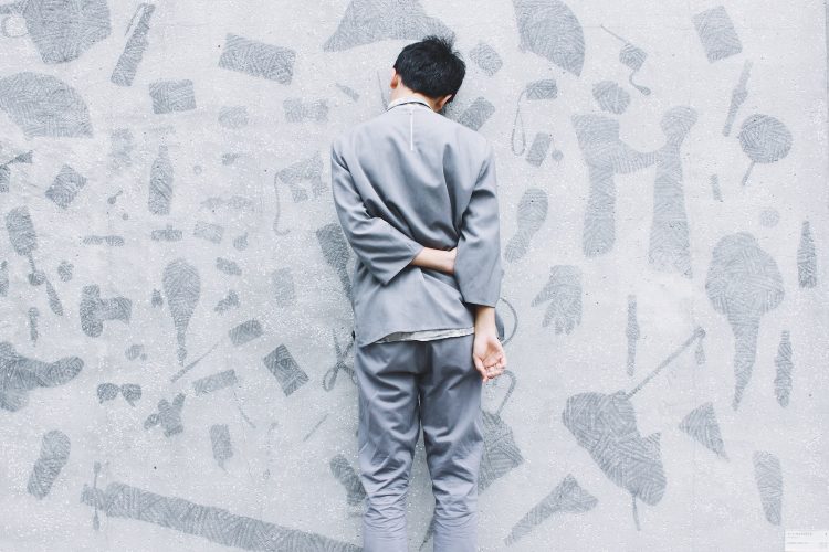 man standing in front of wall