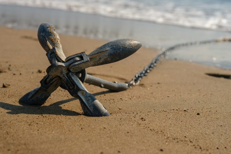 a metal object sitting on top of a sandy beach