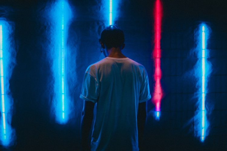 man standing near blue LED strips