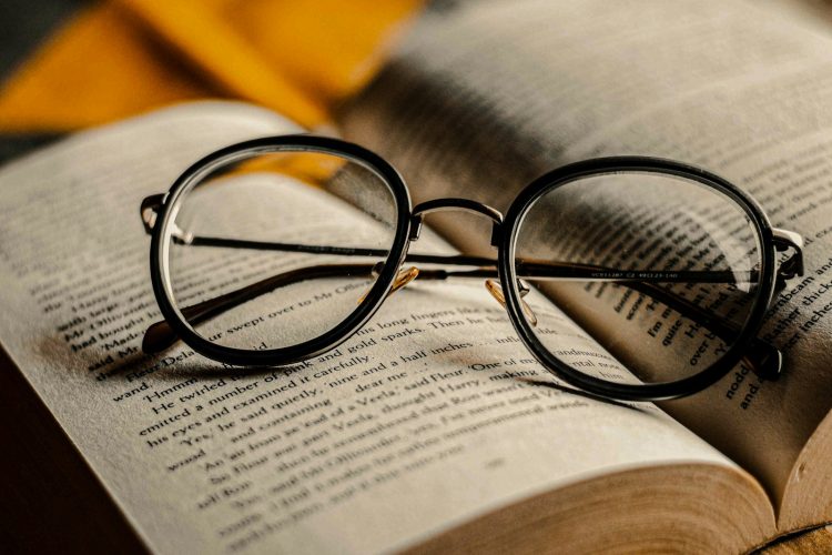 black framed eyeglasses on book page