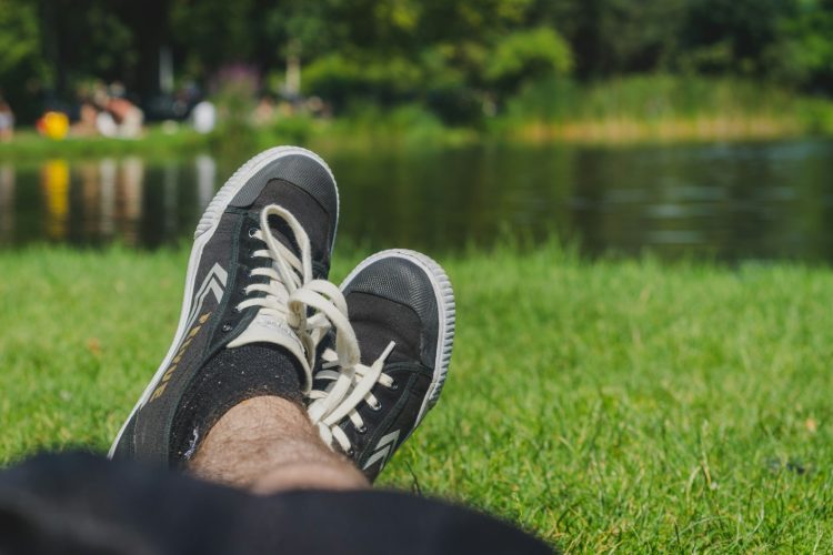person wearing black and white sneakers