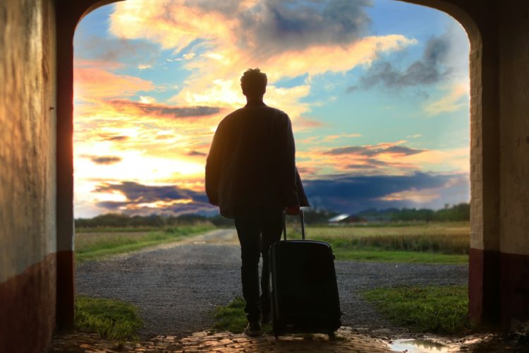 man holding luggage photo
