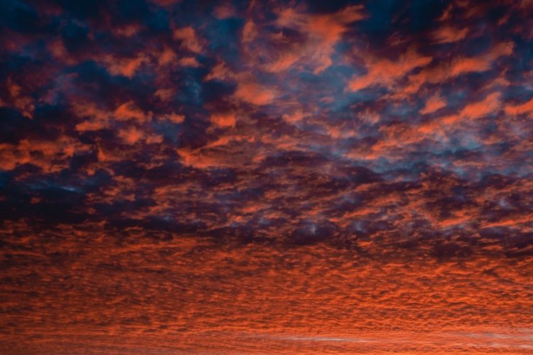 a red sky with a few clouds in it