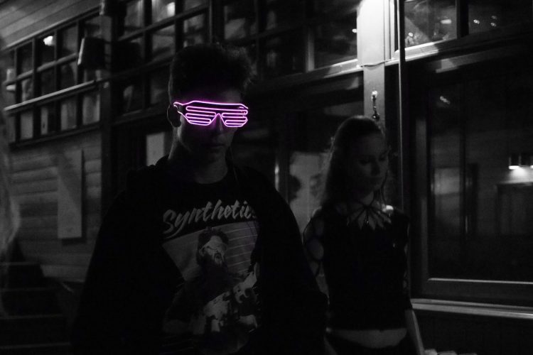 selected color of pink sunglasses wearing man in black jacket