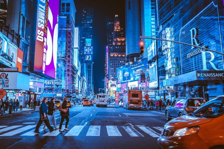 people walking on pedestrian lane during night time