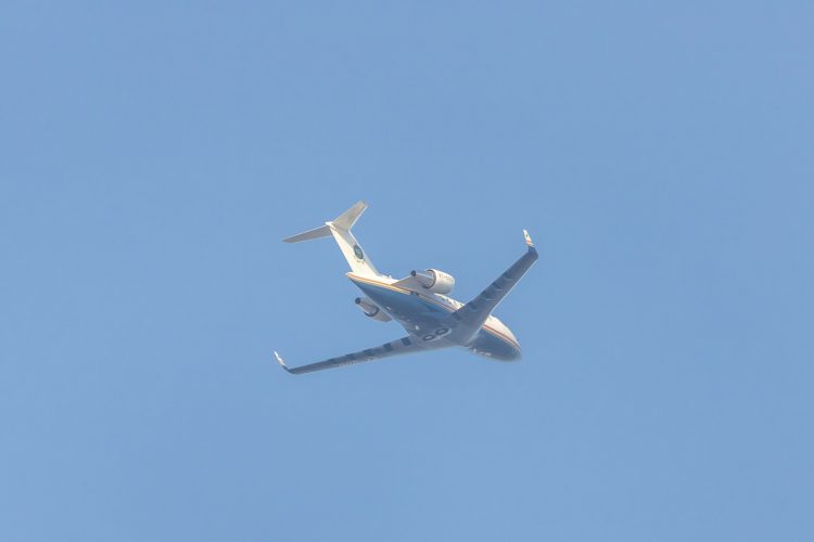 a large jetliner flying through a blue sky