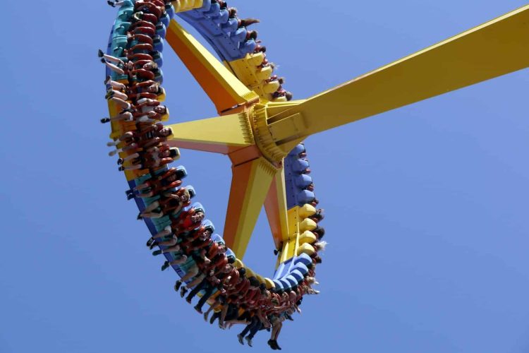 low-angle photography of people on yellow playground equipment