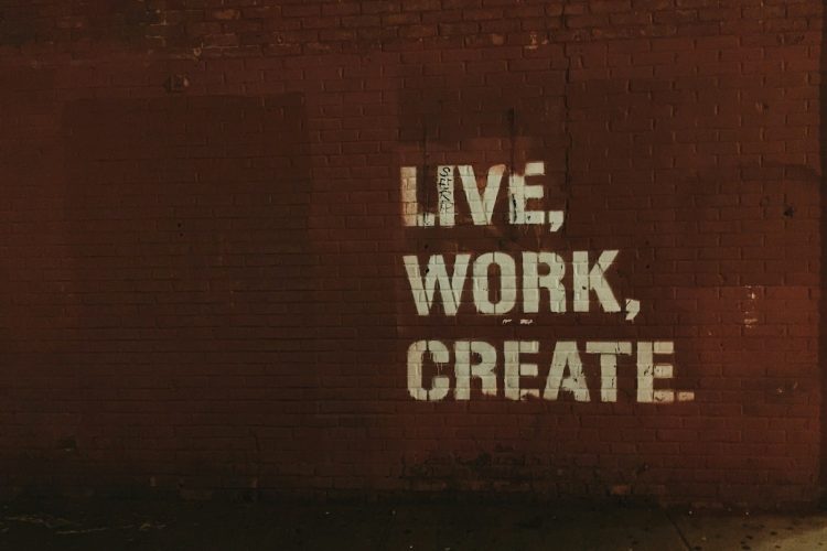 red brick wall with live, work, create. quote