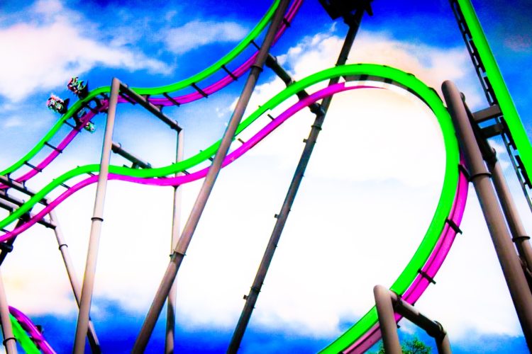 a roller coaster in the middle of a cloudy sky