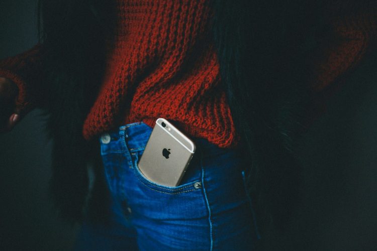 gold iPhone 6 on person's pocket