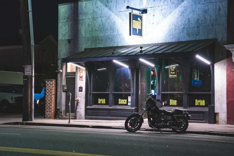 a motorcycle parked in front of a building at night